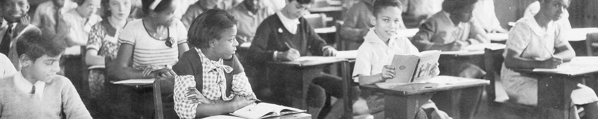 Students sitting at their desks doing work. Circa 1940-1950.