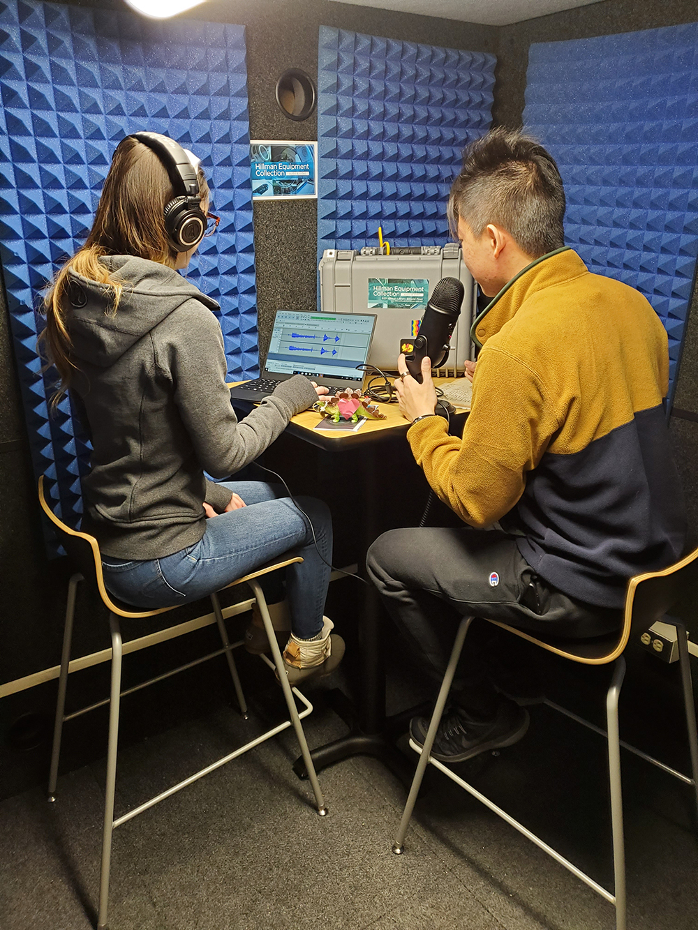 Two students in the Whisper Room recording a podcast.