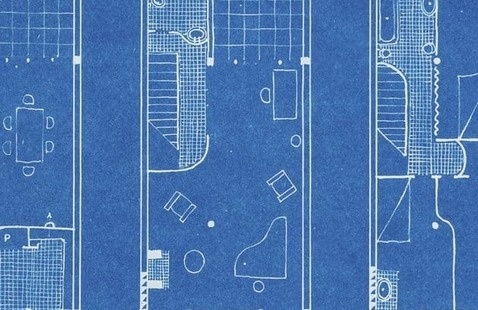 Cyanotype-style blueprint of a floor plan with multiple rooms and furniture layouts drawn in white on a blue background.
