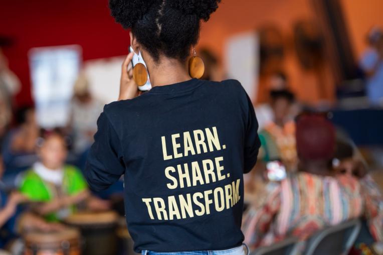 Student tshirt that says learn, share, transform.
