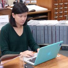 Stephanie doing research on a laptop